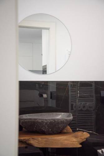 a bathroom with a stone sink and a mirror at Villa Alisha Mountain View in Casargo