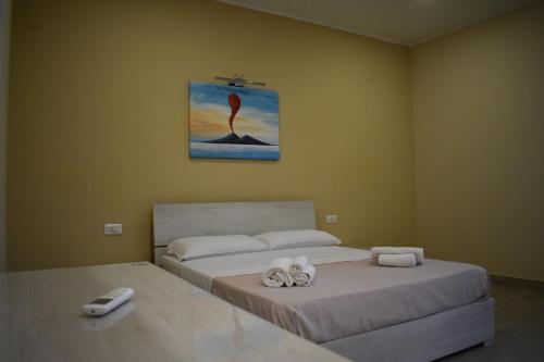 a bedroom with two beds and a painting on the wall at VillART Pompei Guest House in Pompei