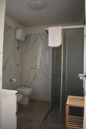 a bathroom with a toilet and a shower stall at VillART Pompei Guest House in Pompei