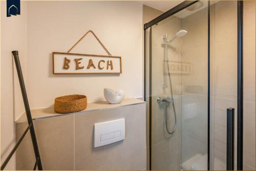 a bathroom with a shower and a sign that reads beach at FeWo 11 "Seelenwind" in Benz