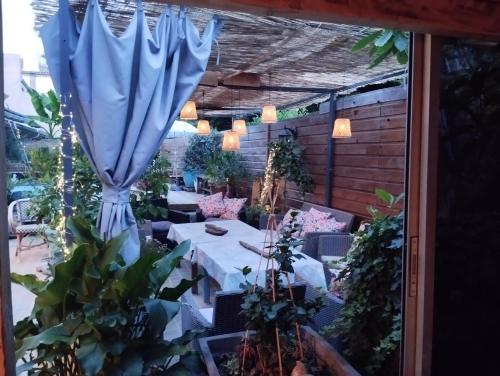 a patio with a table and an umbrella at Ô fil de L'ô in Clairac