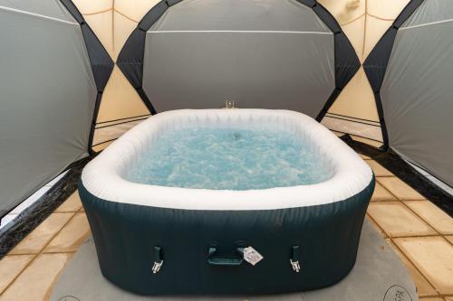 a hot tub in a tent with water in it at Open Mind Property- Stylish 3BR, HotTub & Parking in Portsmouth