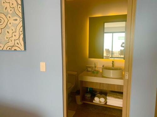 a bathroom with a sink and a mirror at Piedra Azul in Playa del Carmen