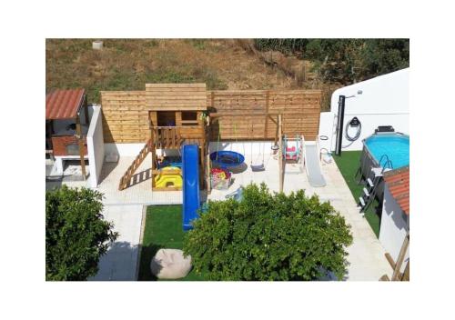 an aerial view of a backyard with a playground at Santinho House - com carregador de carros eléctricos in Ferreira do Alentejo