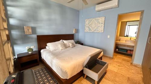 a bedroom with a bed and a bathroom at Piedra Azul in Playa del Carmen