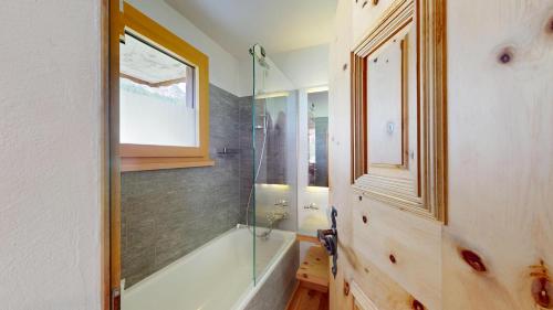 a bathroom with a shower and a glass shower stall at Abitaziun Chüderas 12 in La Punt-Chamues-ch