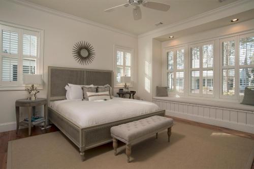 a bedroom with a bed and a fan and windows at 2 Bedroom Wilson Village Home 5049 in Bluffton