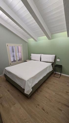 a large bed in a room with green walls at RESIDENZA GIULIA e LIDIA - PERLA DELL'ADRIATICO in Grottammare