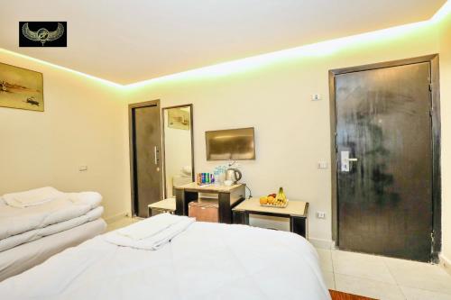 a bedroom with a bed and a desk in it at Comfort in Cairo