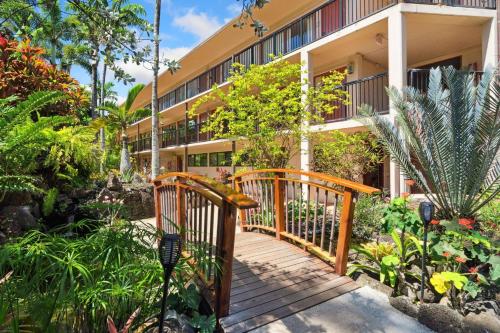 a wooden walkway in front of a building with plants at Prince Kuhio 2-7 in Koloa