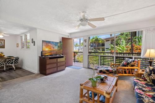a living room with a couch and a ceiling fan at Prince Kuhio 2-7 in Koloa