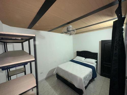a bedroom with a bed and two bunk beds at Casa Stay Villa de Guaduas in Guaduas
