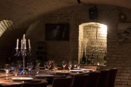 a long table in a room with wine glasses at Agape Villa Apartments in Novi Sad