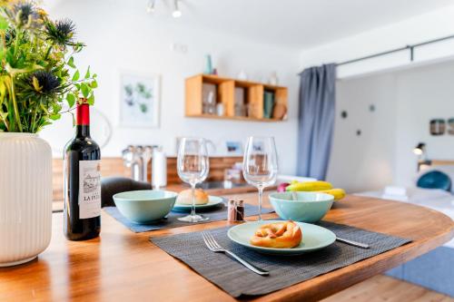 a table with a bottle of wine and two glasses at Ostsee, wunderschöne Wohnung mit Meerblick in Harrislee
