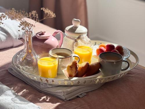 a tray of breakfast foods and drinks on a table at Maison des Passeroses in Boutiers-Saint-Trojan