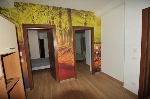 a hallway with three doors and a painting on the wall at B&B da Choco in Vitulano