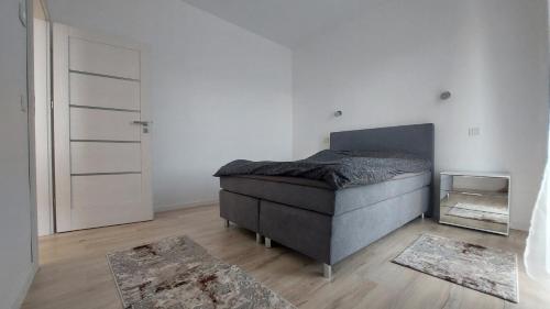 a bedroom with a bed and a door with rugs at Andree Studio in Târgu-Mureş