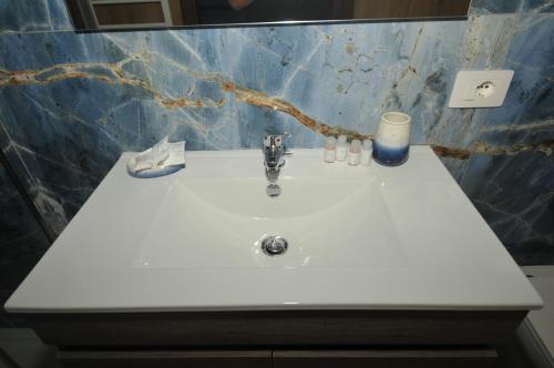 a white sink in a bathroom with a candle at B&B da Choco in Vitulano