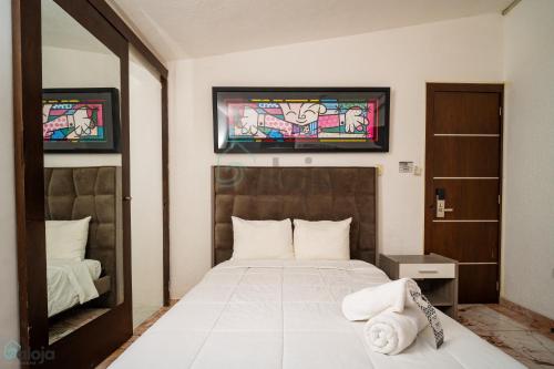 a bedroom with a bed and a stained glass window at Hotel Boutique Maraf Cancun in Cancún