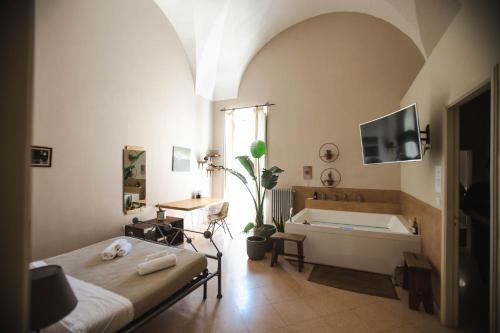 a bedroom with a bed and a bath tub at 4 Balconi rooms-Boutique B&B in Lecce