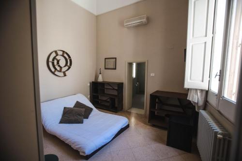 a bedroom with a bed and a desk and a window at 4 Balconi rooms-Boutique B&B in Lecce