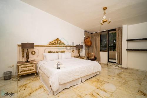 a bedroom with a large white bed and a large window at Hotel Boutique Maraf Cancun in Cancún