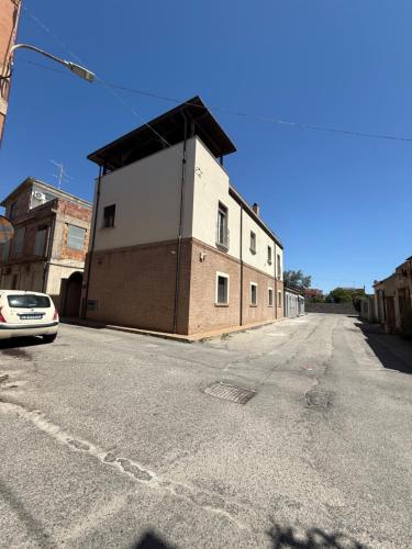 a building on the side of an empty street at Cadorna36 in Locri