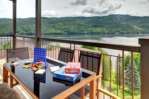 a table on a balcony with a view of a river at Magnifique VUE LAC et SKI in Mont-Tremblant