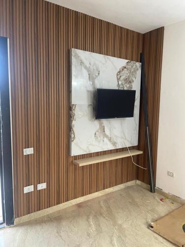 a flat screen tv on a wall in a room at شقة مبارك in Hurghada