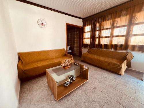 a living room with a couch and a table at Budget Family House in Mirodháton