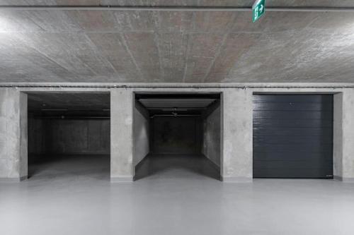 two garage doors in a parking garage with a street sign at Luxury 2 Bedroom Mountain Escape in Harrachov
