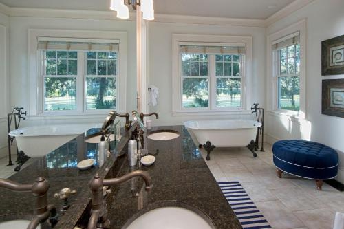 a bathroom with two sinks and a tub and a bath tub at 5 Bedroom Wilson Village Home 33 in Bluffton