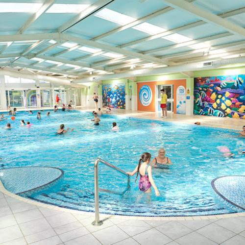 a group of people in a swimming pool at Hummingbird Retreat in Blackpool