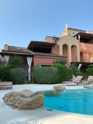 a swimming pool in front of a house at Cascina Jesolana in Lido di Jesolo