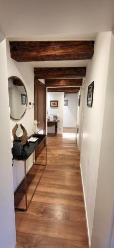 a hallway with white walls and wooden ceilings at Gîte Du XVe in Kaysersberg