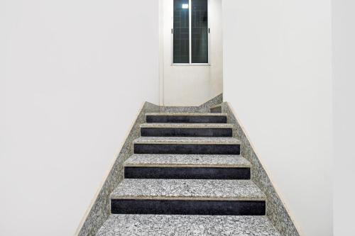 a staircase leading up to a white building at Super Townhouse Sahayogi Nagar Near Big Bazaar in Dhanbād