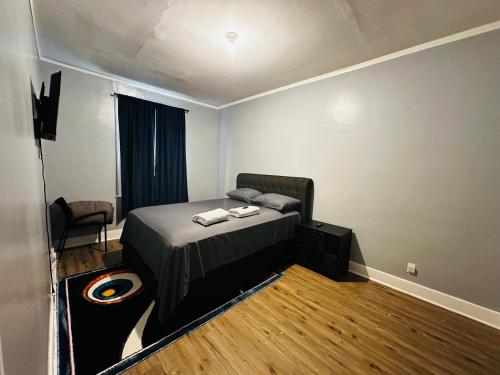a bedroom with a bed and a chair in it at Cozy in Hyde Park Greater Grand Crossing in Chicago