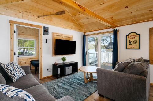 a living room with a couch and a tv at Arbutus Lakeview-Fishing-Pet Friendly-Near TC! in Traverse City