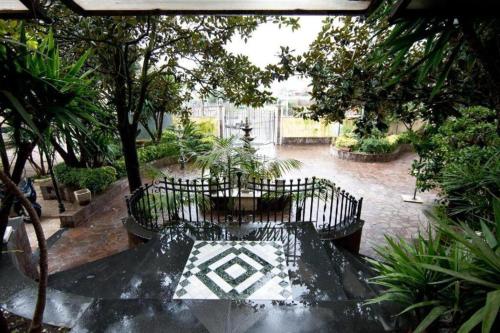 a bench in a courtyard with trees and plants at Pompei Ruins in Torre Annunziata