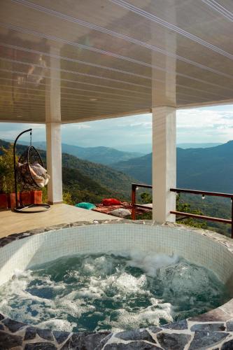a jacuzzi tub with a view of the mountains at Glamping Pedro in San Gil