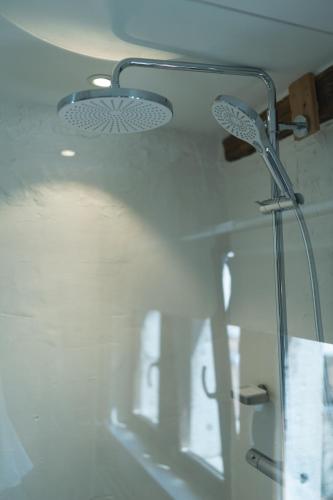 a glass shower in a bathroom with a ceiling at Appartement atypique - coeur historique de Liège in Liège