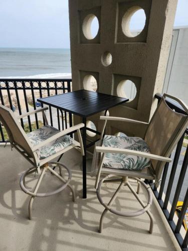 a table and two chairs on a balcony with the ocean at Virginia one #517 in Rehoboth Beach