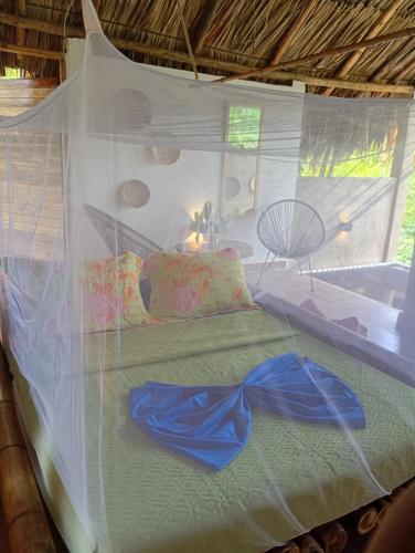 a bed in a room with a net at The Valley Tayrona hostel- A social jungle hostel in El Zaino