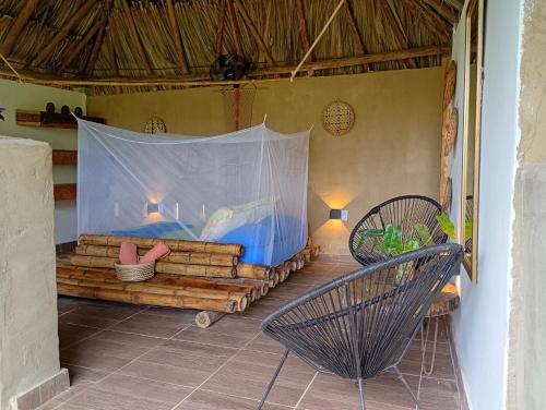 a room with a bed with a mosquito net at The Valley Tayrona hostel- A social jungle hostel in El Zaino
