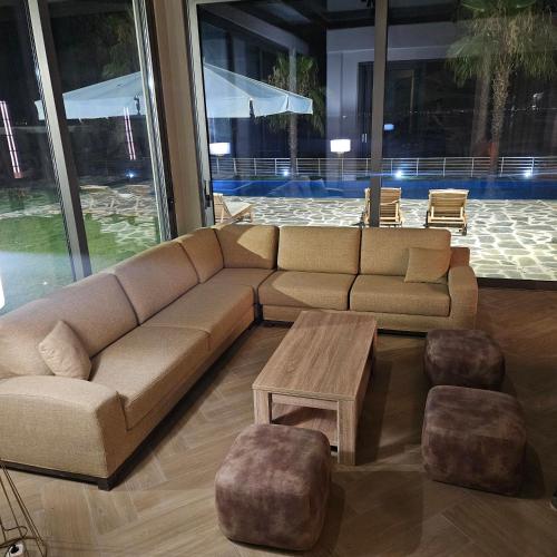 a living room with a couch and a coffee table at Evia Palm Beach Villa in Politiká