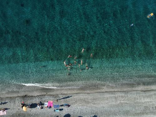 an overhead view of a beach with people in the water at AGATHA appartments PALIOURIA in Kókkinon Nerón