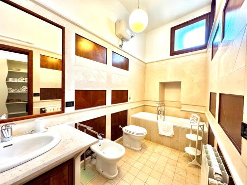 a bathroom with a sink and a toilet and a tub at La Torretta - Marea Stays Collection in Otranto