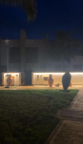 a building with lights in a yard at night at Luxury Apartment Marroco Saidia Cheap in Saidia 