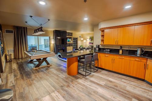 a large kitchen with a ping pong table in it at 2100 SqFt Penthouse Suite W/ Strip Views! POOL GYM in Las Vegas