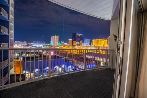 a balcony with a view of the city at night at 2100 SqFt Penthouse Suite W/ Strip Views! POOL GYM in Las Vegas